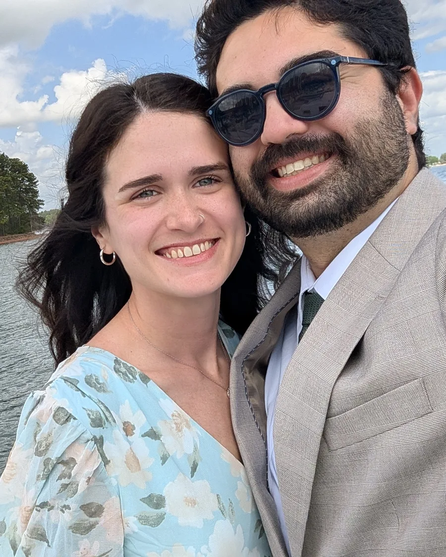 Grant and his wife, Alexis, smiling together by a lake