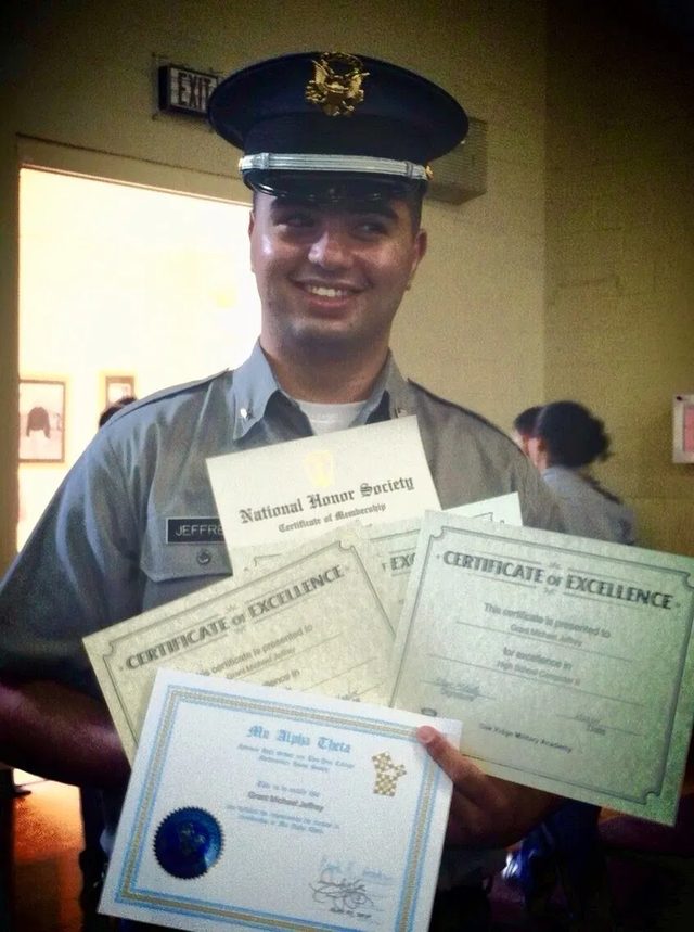 Grant in his Oak Ridge uniform holding his National Honor Society, Mu Alpha Theta and academic excellence certificates