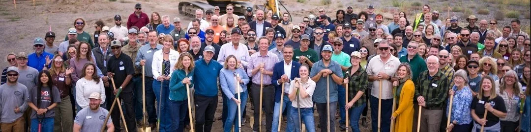 A large crowd holding ceremonial shovels at the Heart of Oregon Corps campus groundbreaking